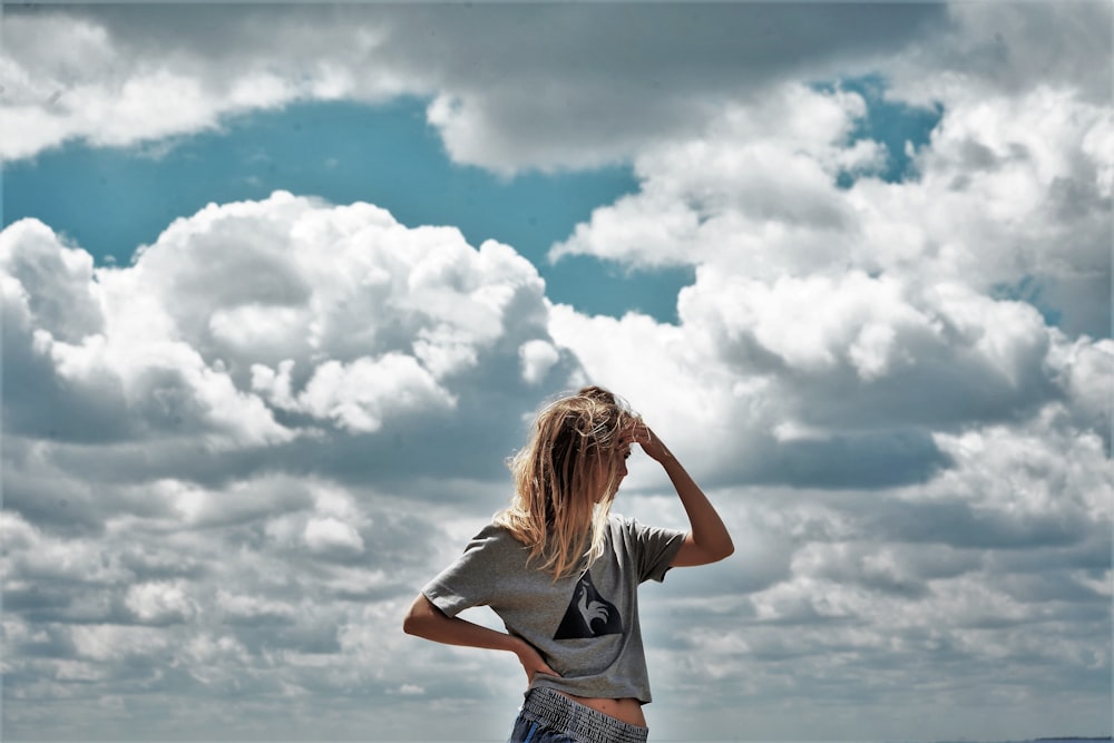 a woman standing on top of a beach next to the ocean