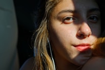 Close-up of a student practicing shadowing technique with headphones on.