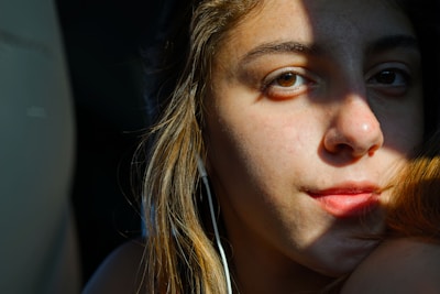 Close-up of a student practicing shadowing technique with headphones on.