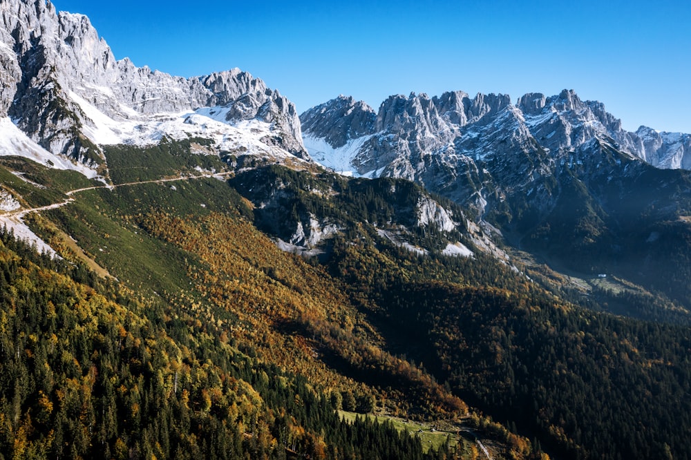 a view of a mountain range with a road going through it