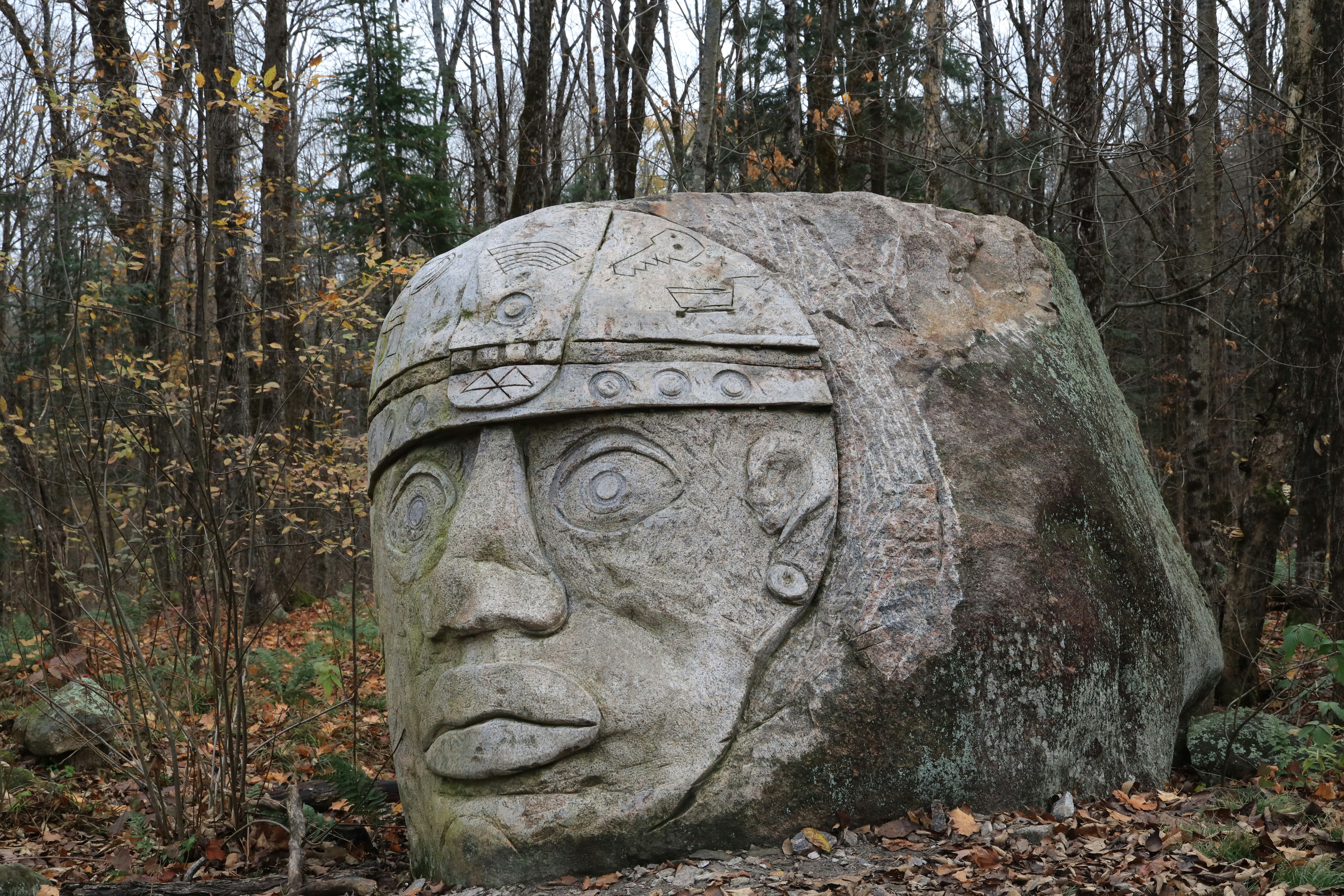 a large rock with a face carved into it