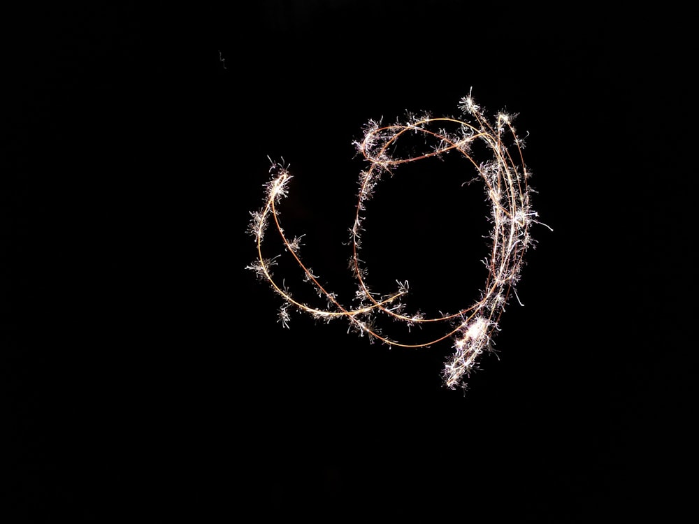 a string of lights in the dark on a black background