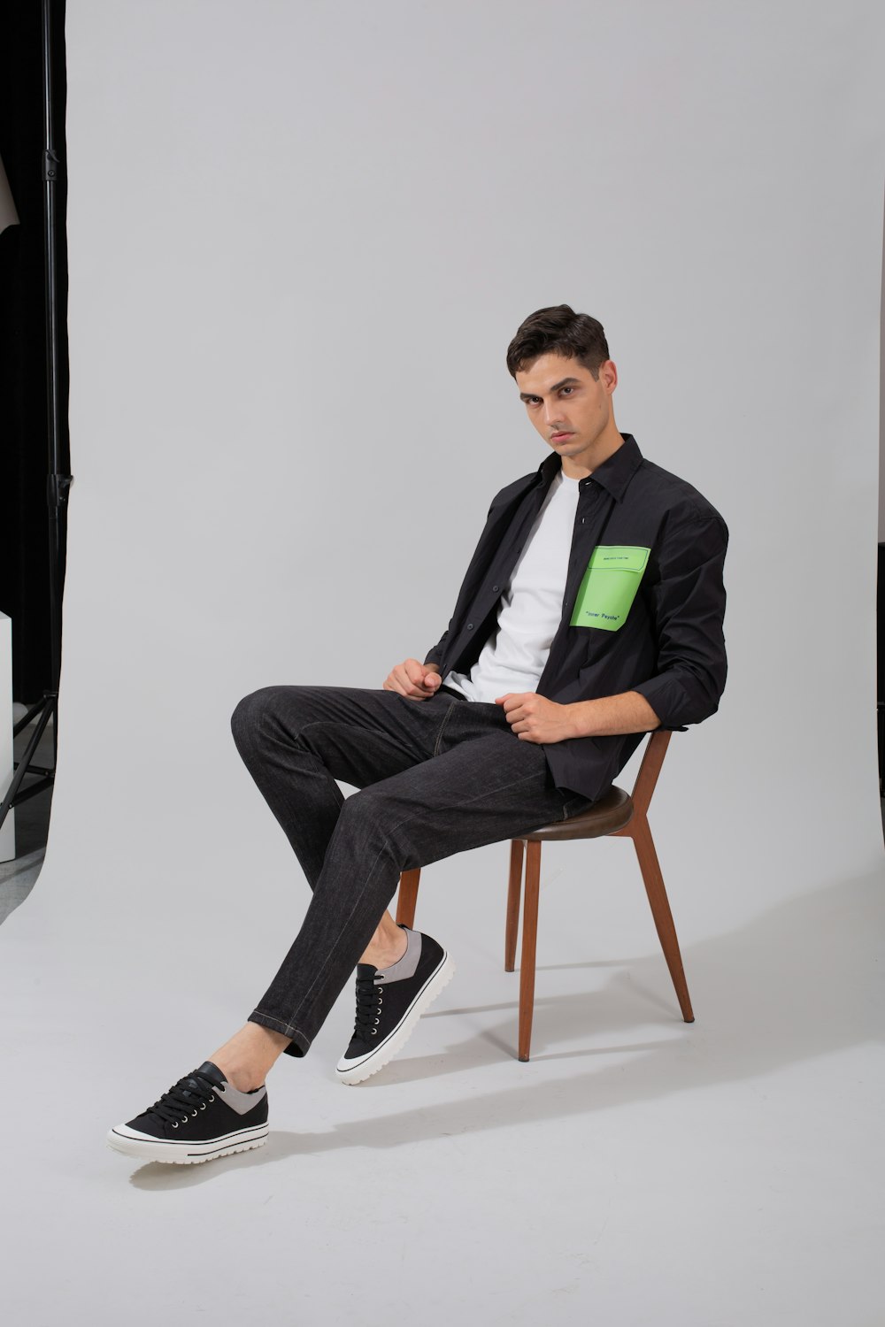 a man sitting on a chair in a studio