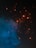 Sparks of bright orange light dance against a dark background, contrasting with a plume of blue smoke swirling upward. The scene conveys movement and energy, with the glowing particles creating a dynamic visual effect.
