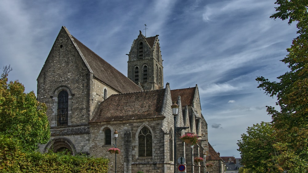 a church with a tall steeple surrounded by trees