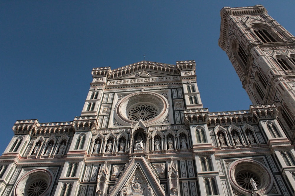 a very tall cathedral with a clock on it's side