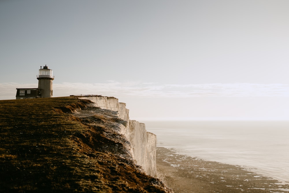 a lighthouse on a cliff overlooking the ocean