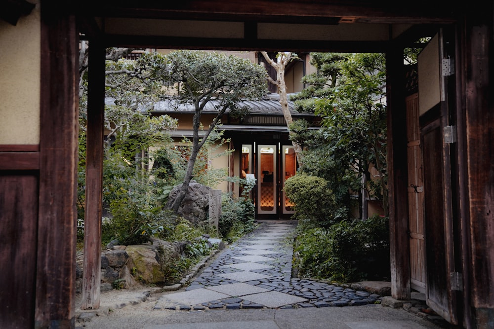 a stone path leading to a building in a garden