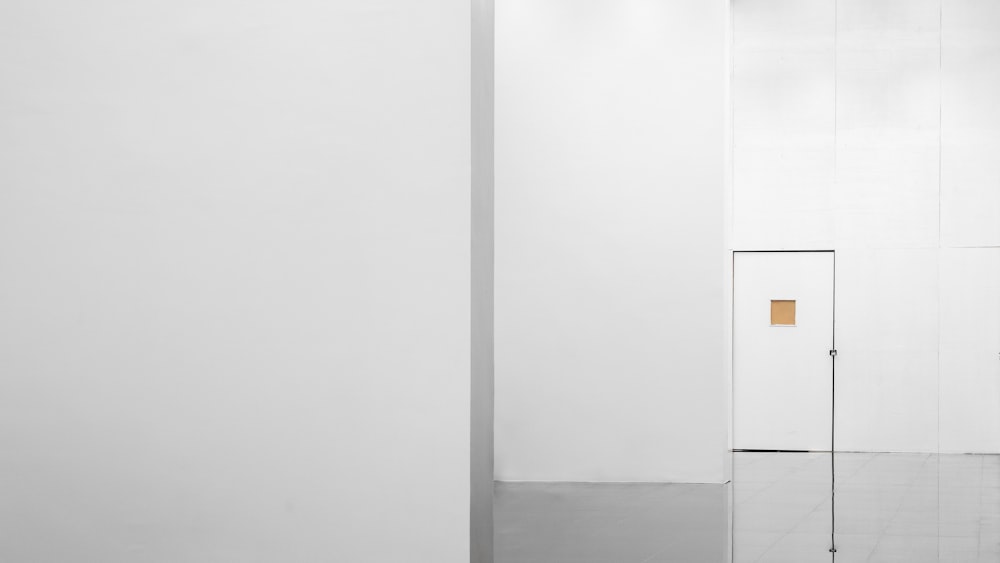 a white room with a white door and a white wall