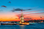 The Maiden Tower on the Bosphorus in Istanbul under a vibrant orange sky