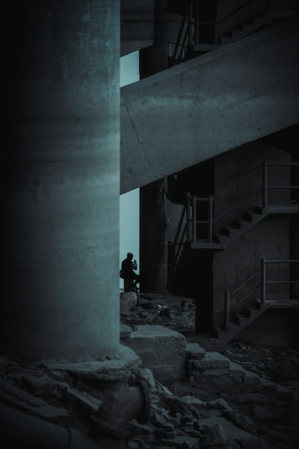 a person sitting on a ledge in a building