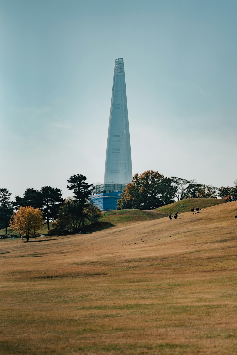 a very tall building sitting on top of a hill