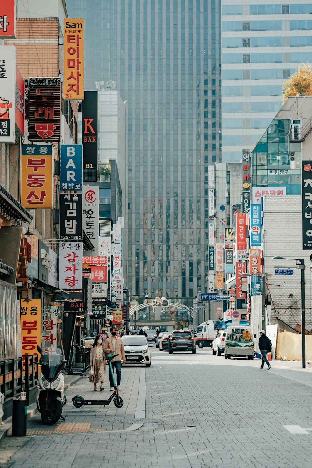 a person riding a scooter on a city street