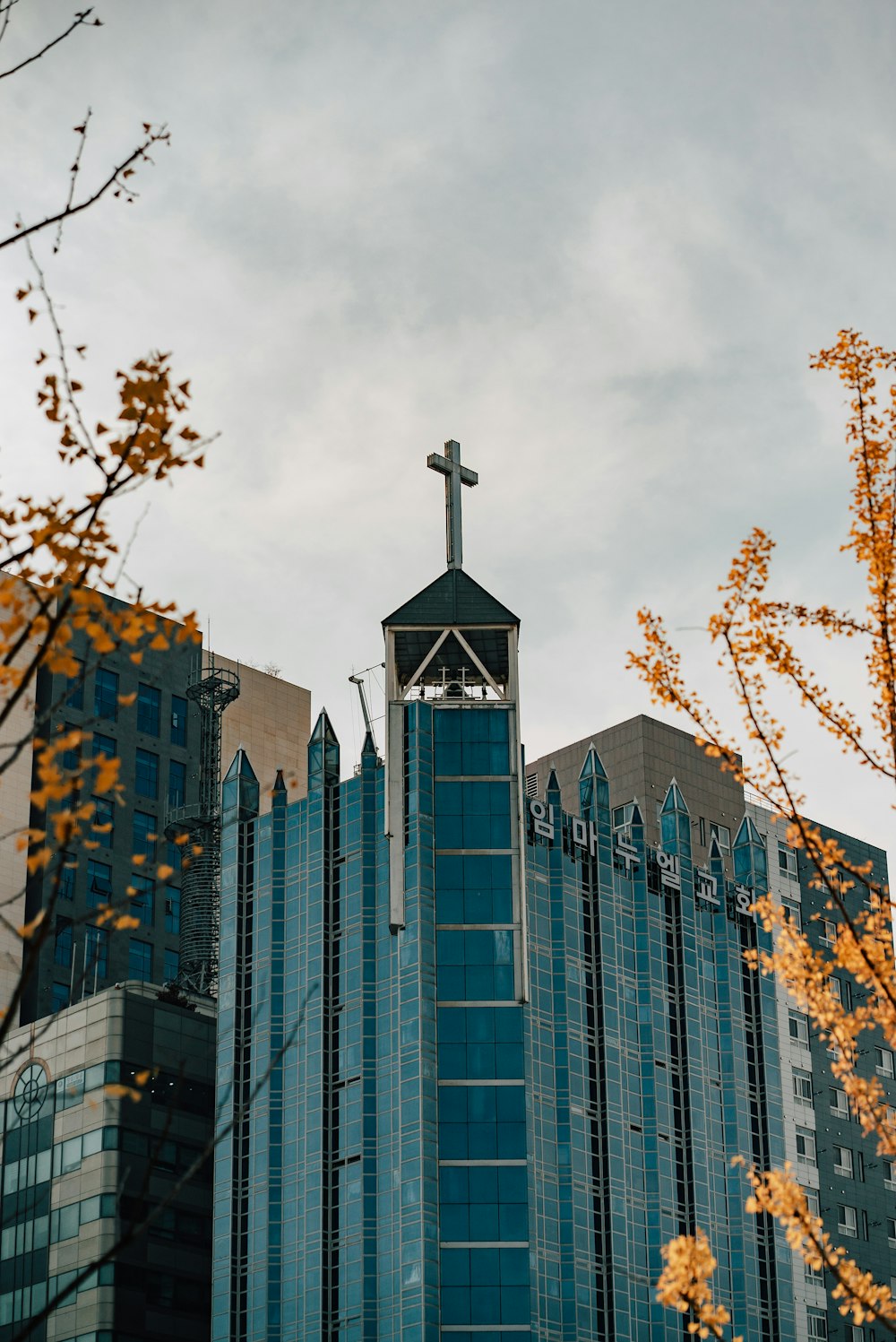 a tall building with a cross on top of it