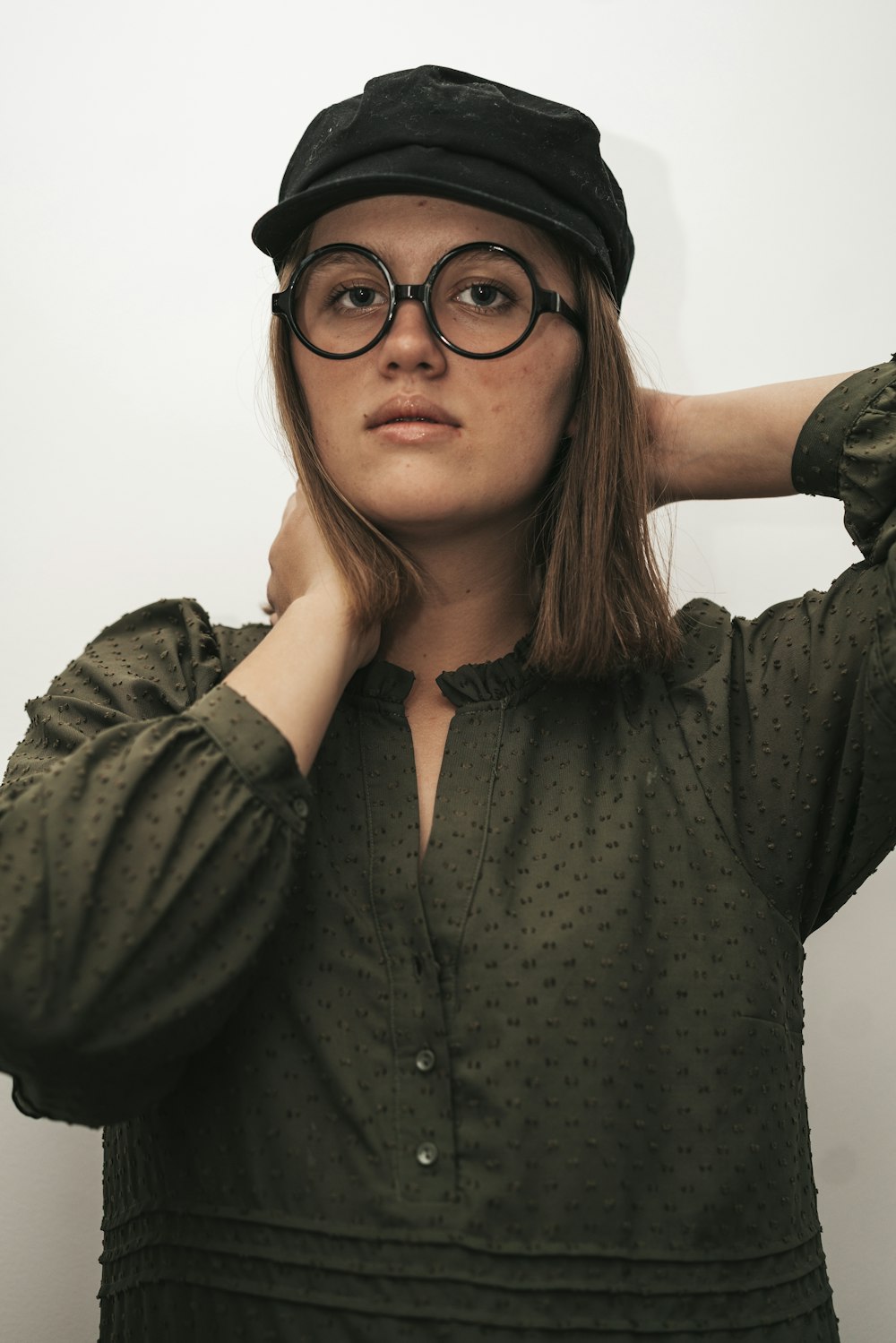 a woman wearing glasses and a hat