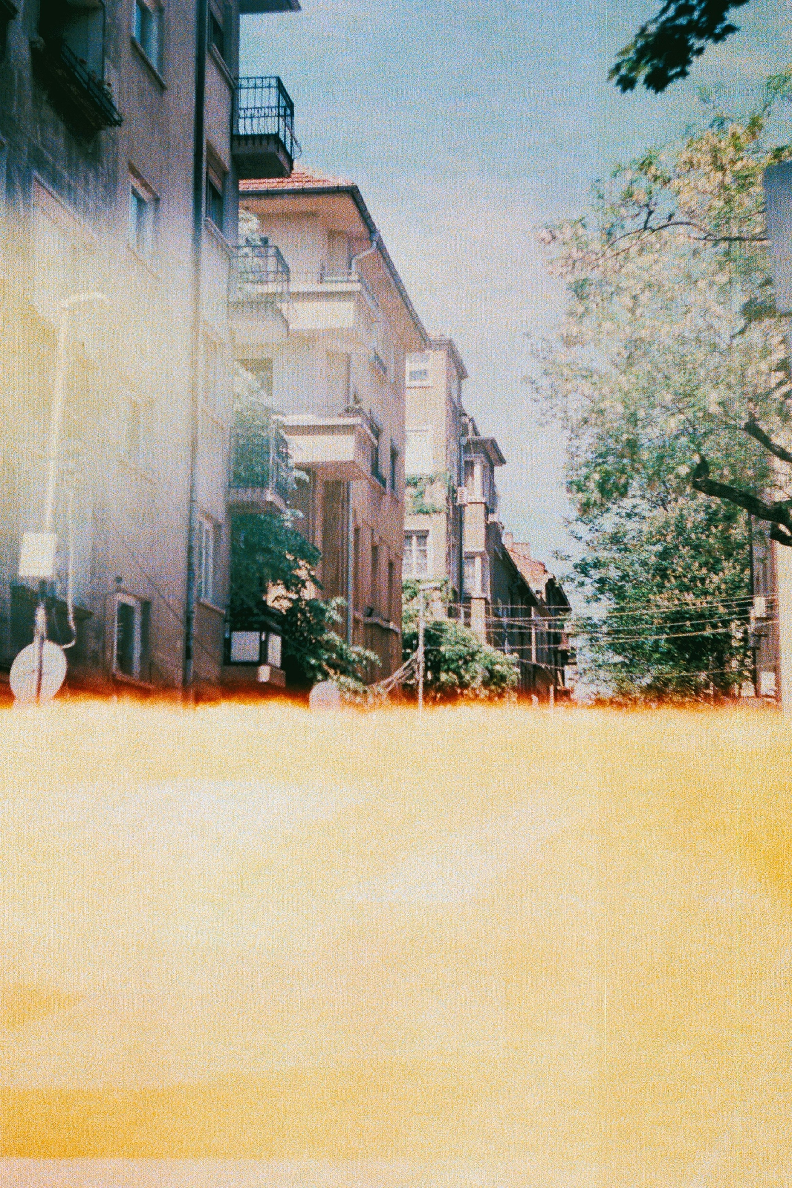 a painting of a city street with tall buildings
