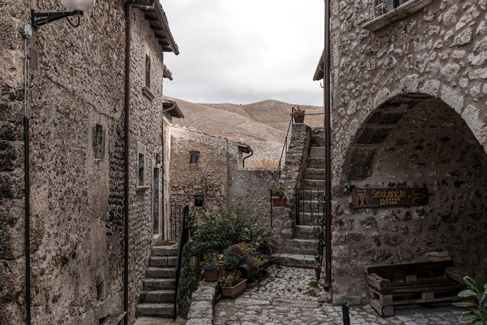 a narrow cobblestone street with stone buildings