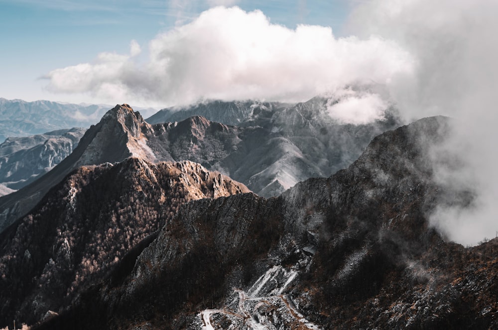 a mountain range covered in clouds and snow