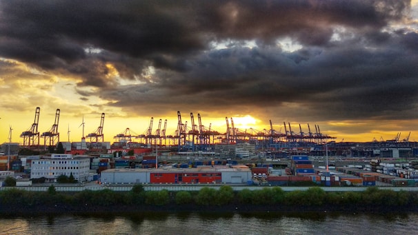 Port infrastructure with cranes and electrical installations at sunset
