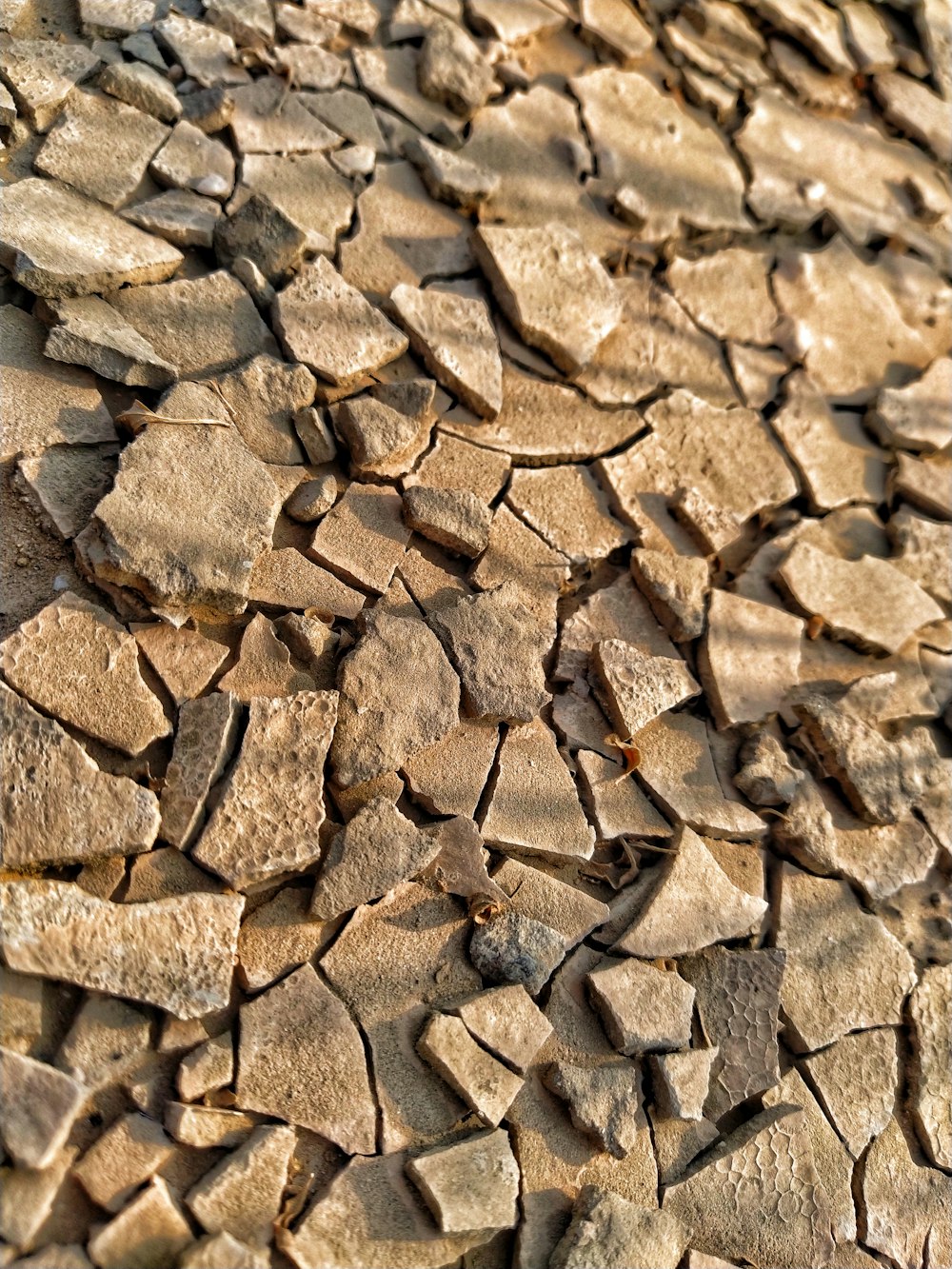 a close up of a rock wall with a cell phone on it