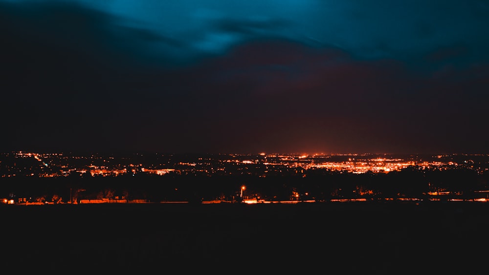 a view of a city at night from a hill