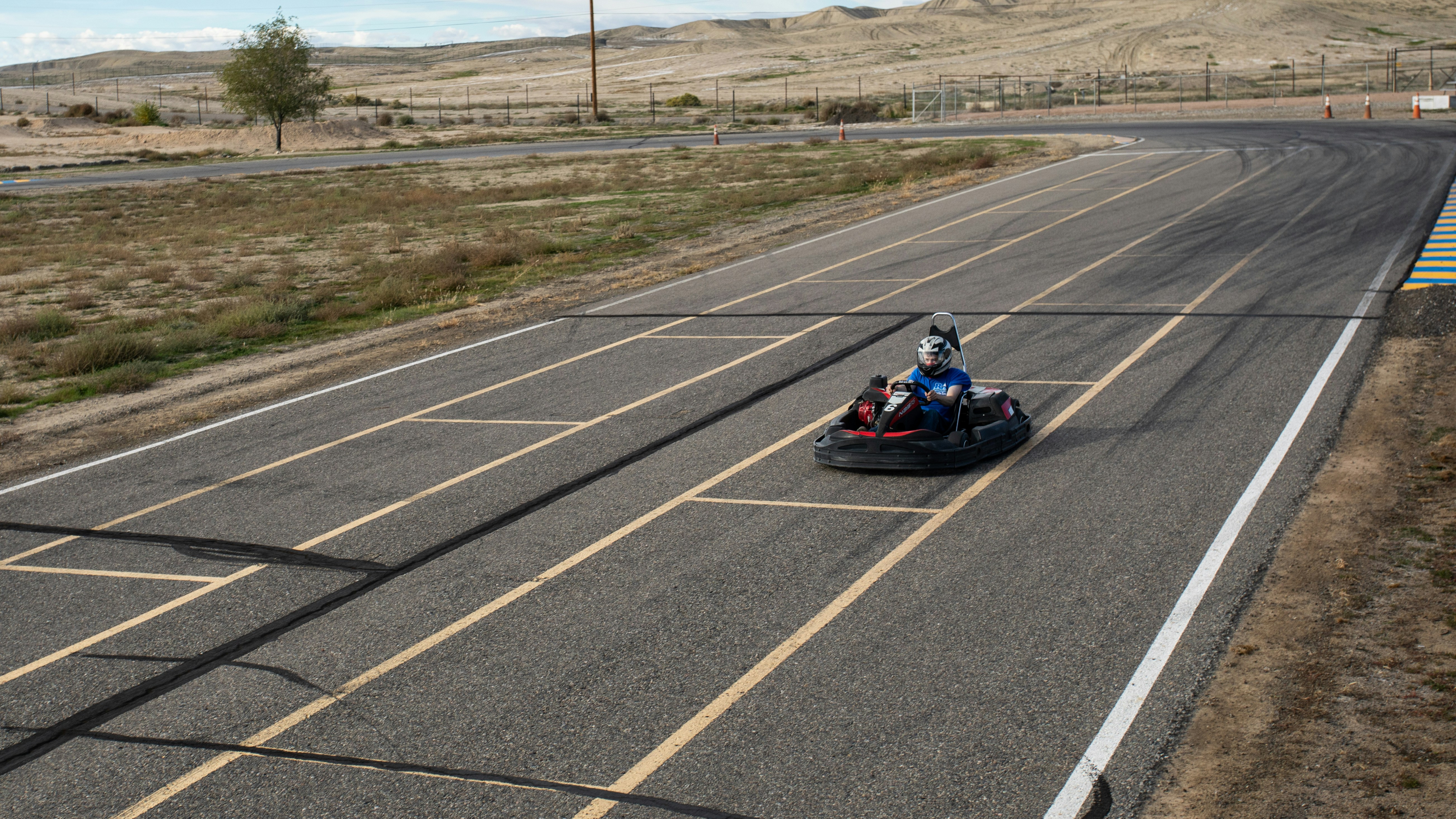 Person riding a bumper car down a road