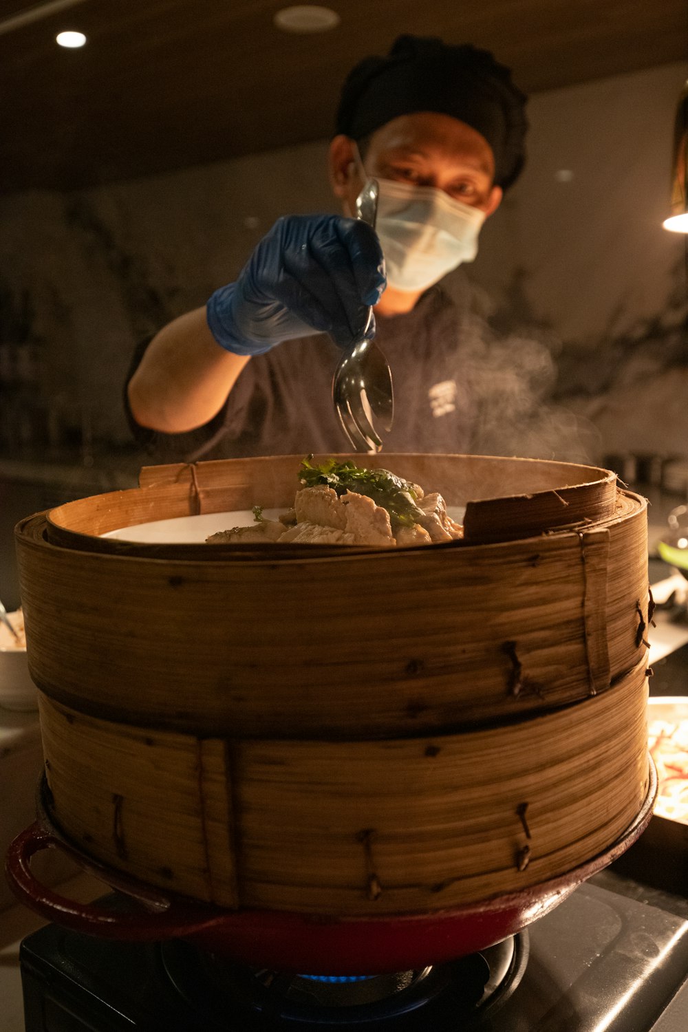 a person in a kitchen cooking food in a basket