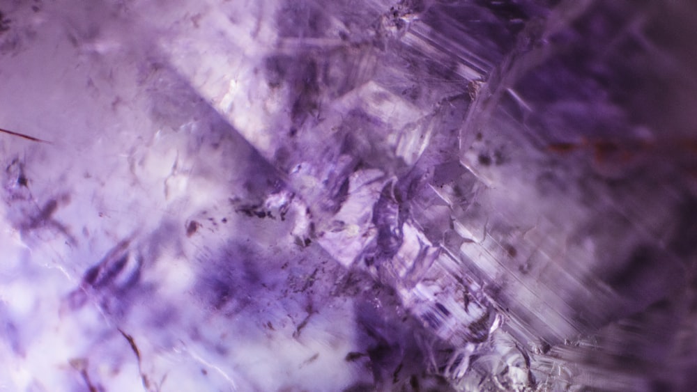 a close up of a rock with purple crystals