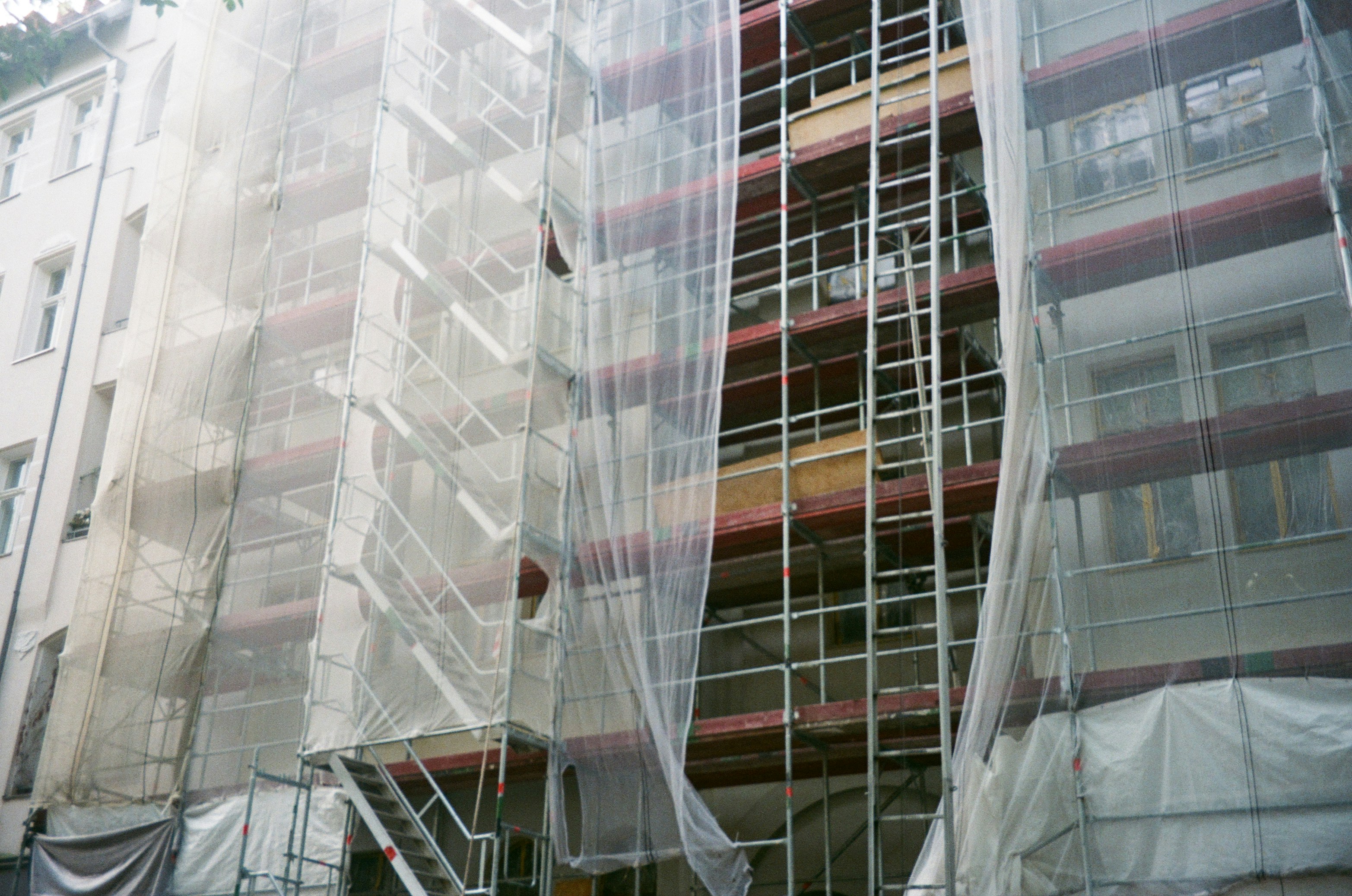Large building with scaffolding wrap