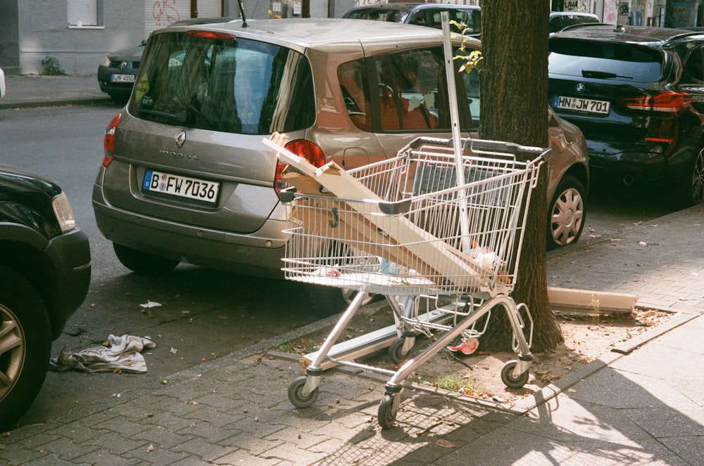 a shopping cart parked on the side of a street