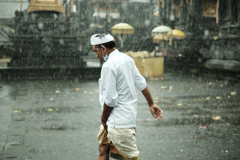 a man walking in the rain with an umbrella