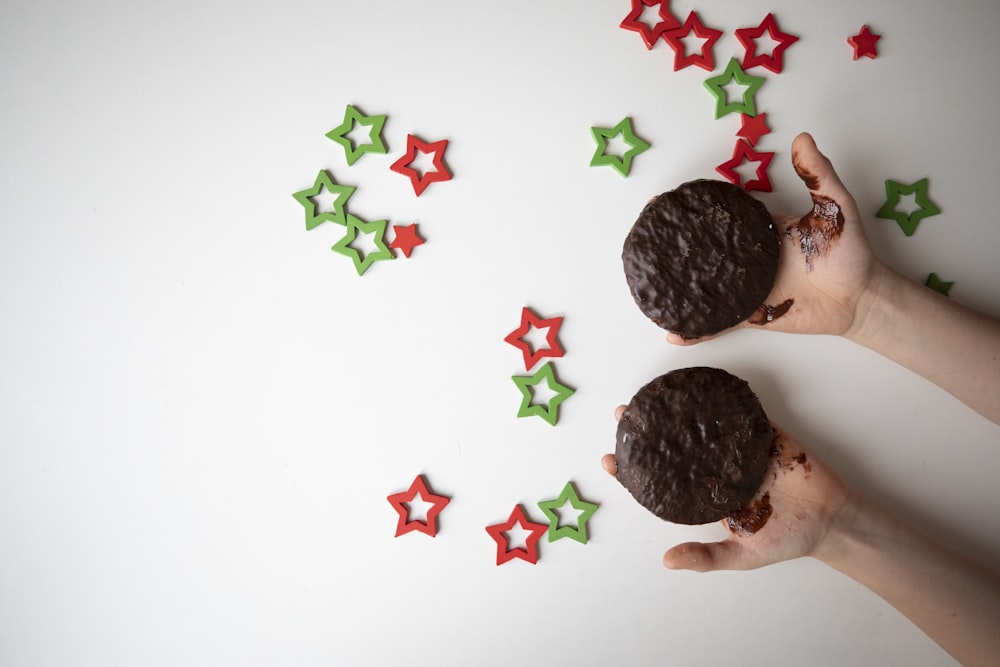 a person holding two cookies in their hands