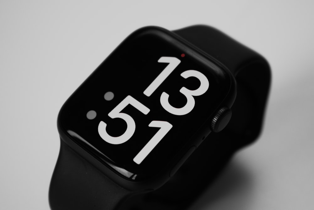 a black apple watch with the time displayed