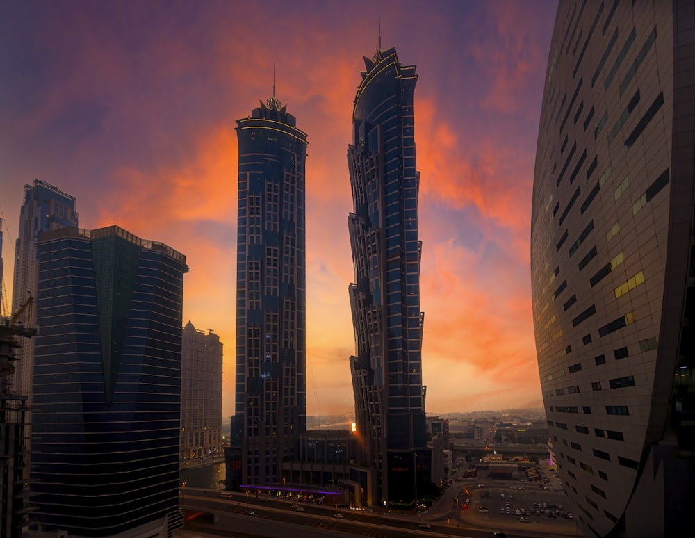 a sunset view of some very tall buildings