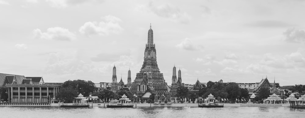 a black and white photo of a city with a lake