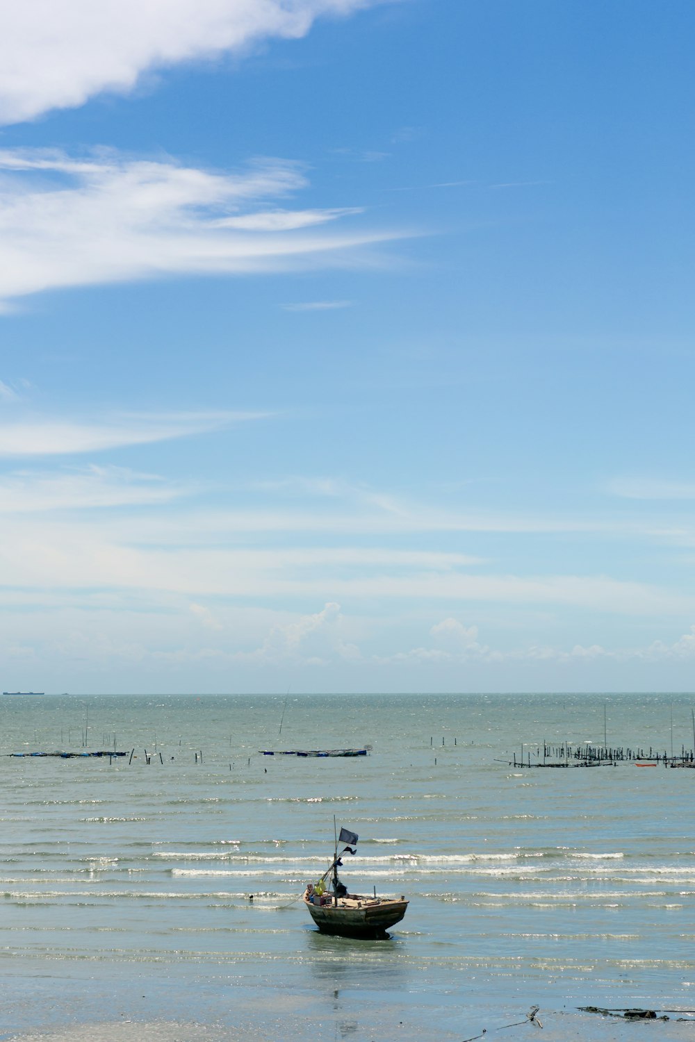 a small boat floating on top of a large body of water