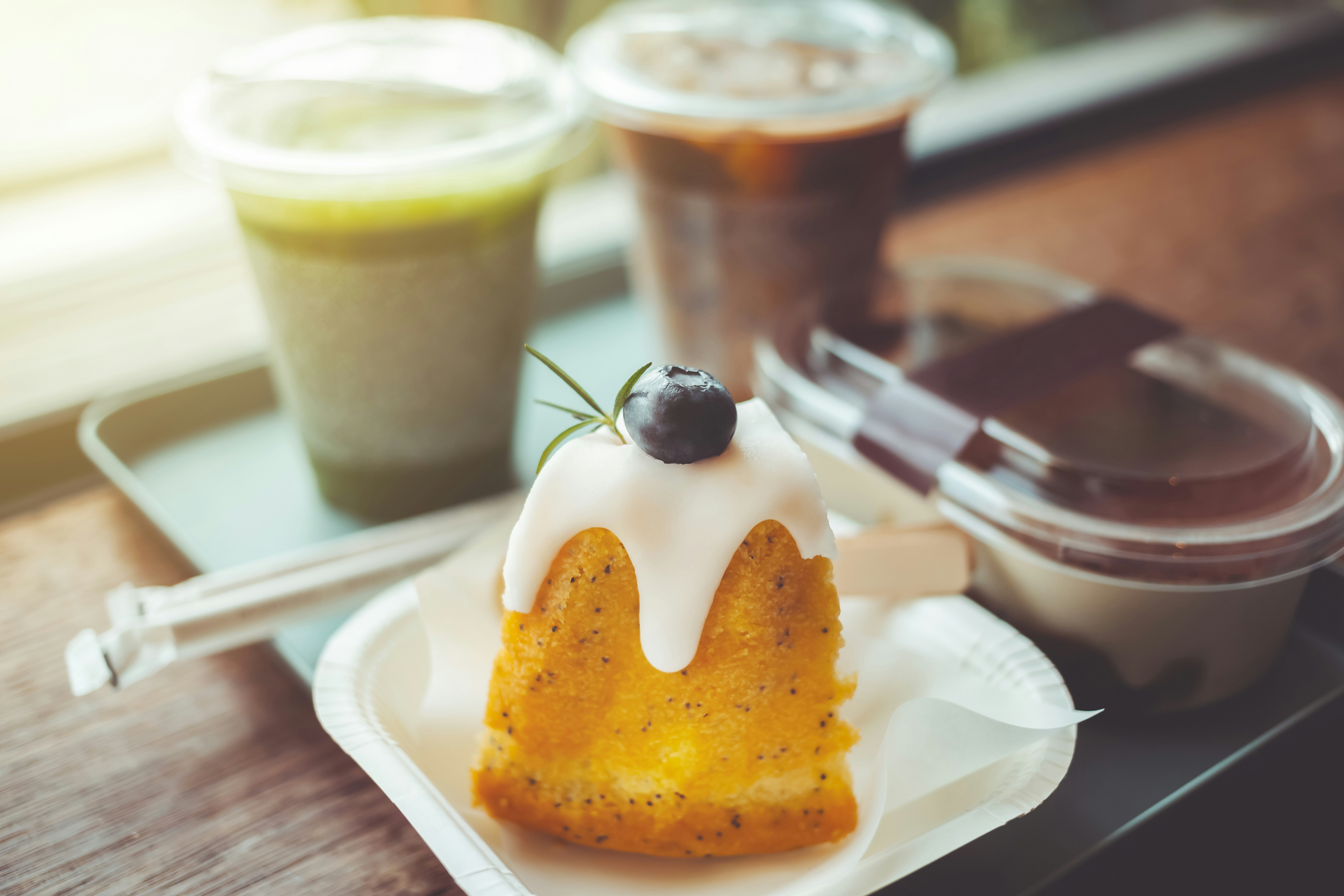 A pastry with a cherry on top of it on a plate