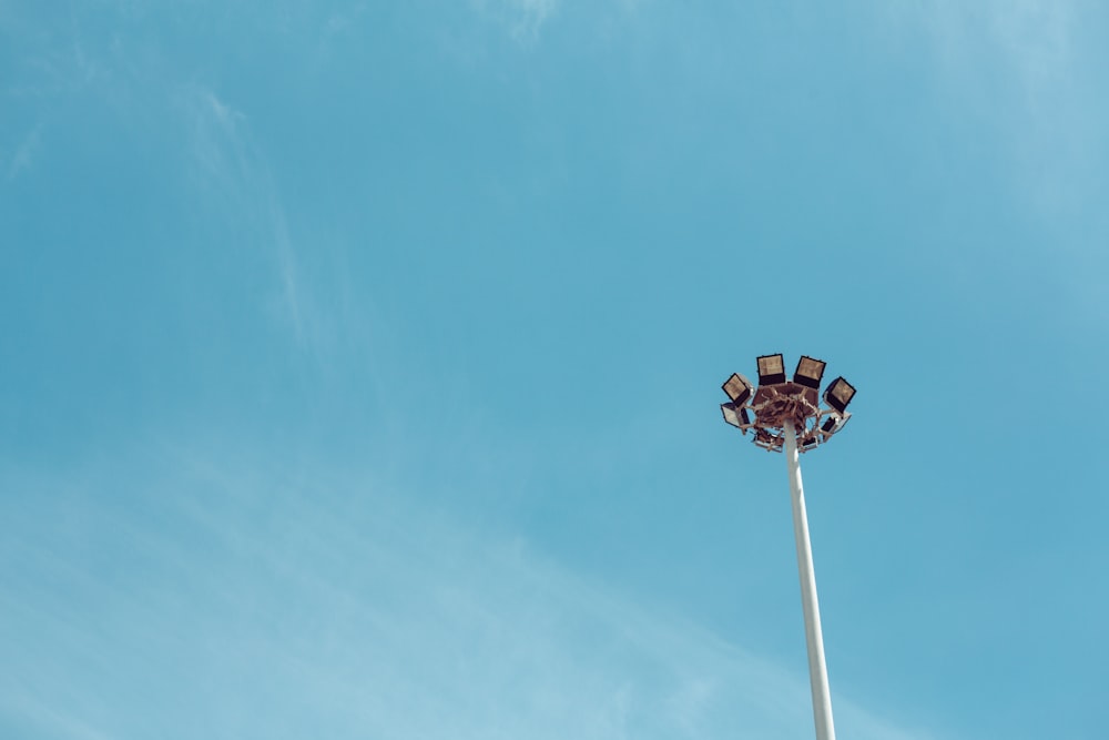 a street light with a blue sky in the background