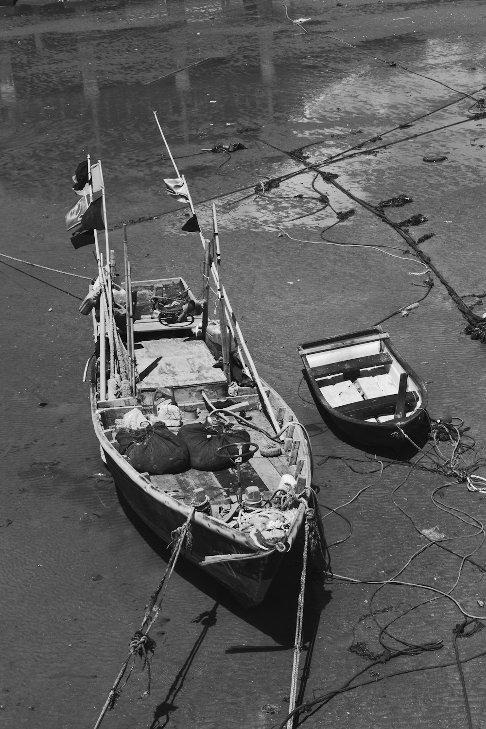 a black and white photo of a boat on the beach