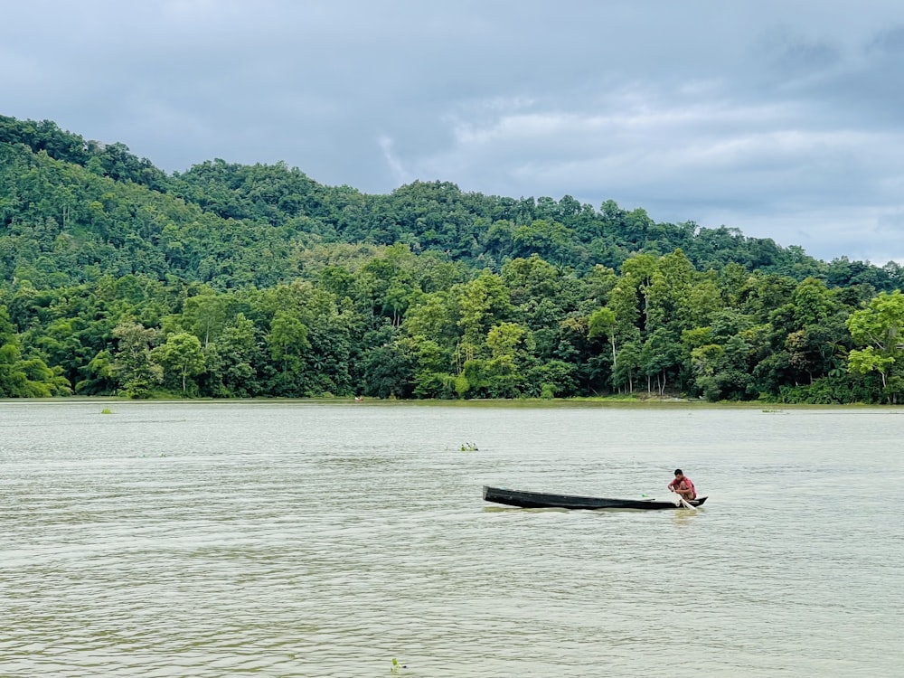 a man in a canoe on a lake