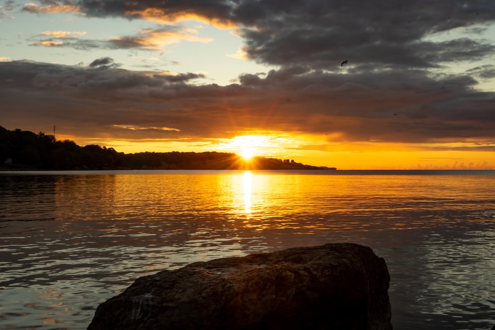 the sun is setting over a body of water