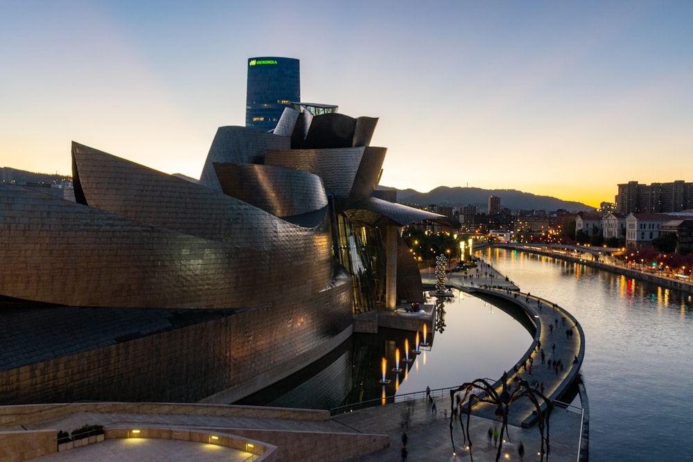 a view of a building next to a body of water