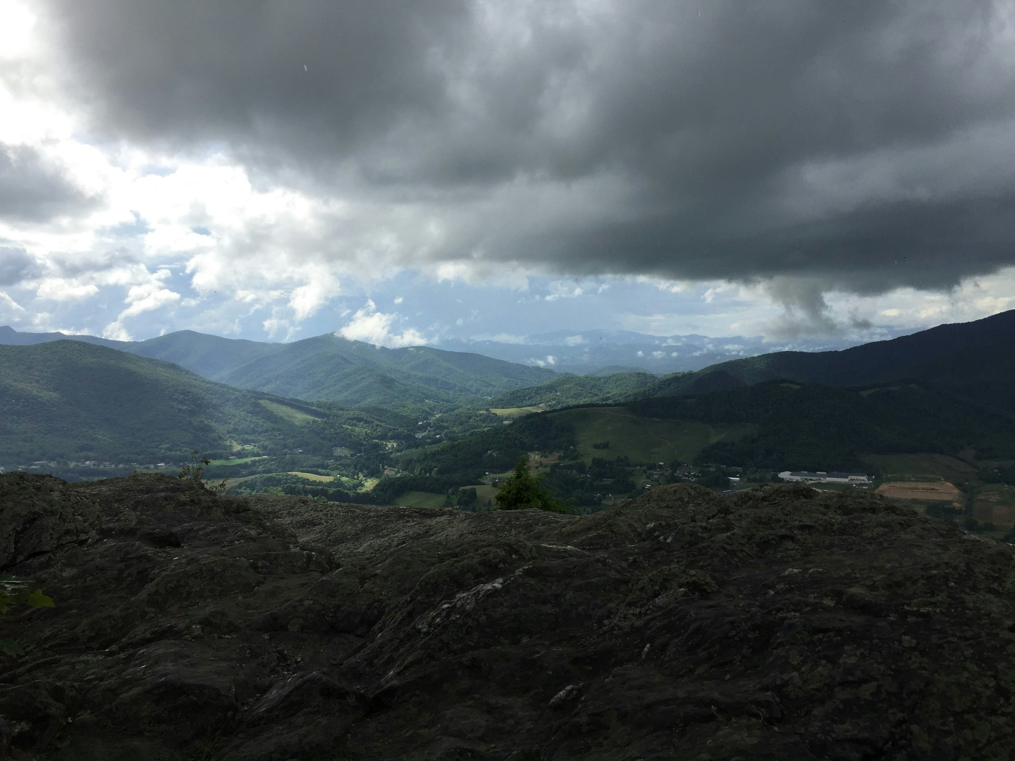 a view of a valley with mountains in the background