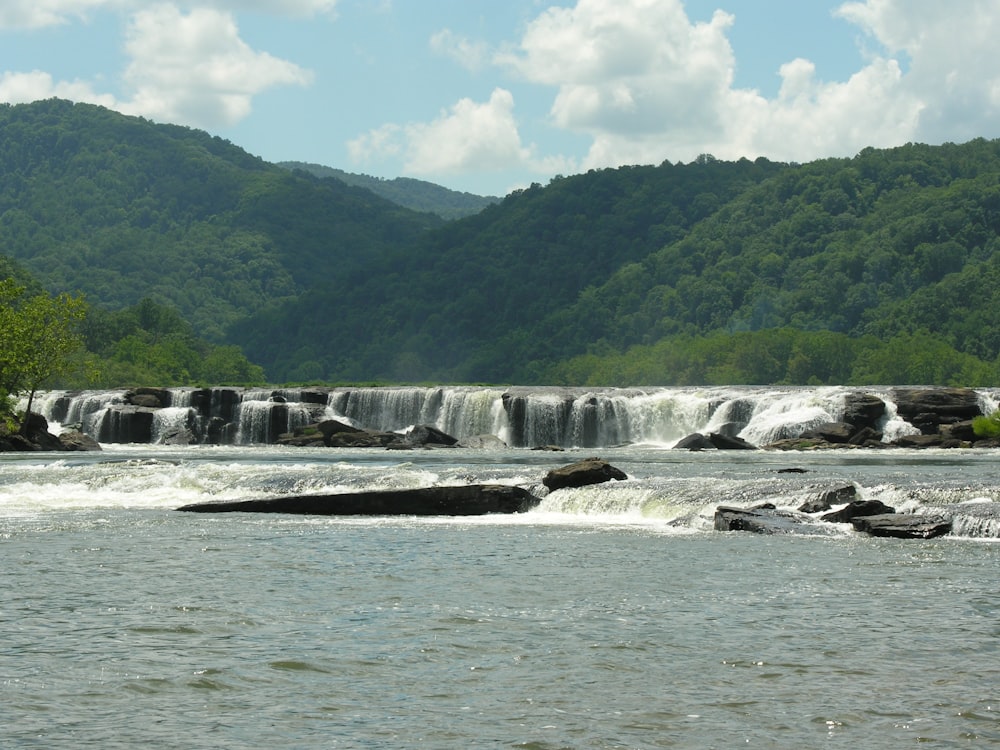 a river with a waterfall in the background