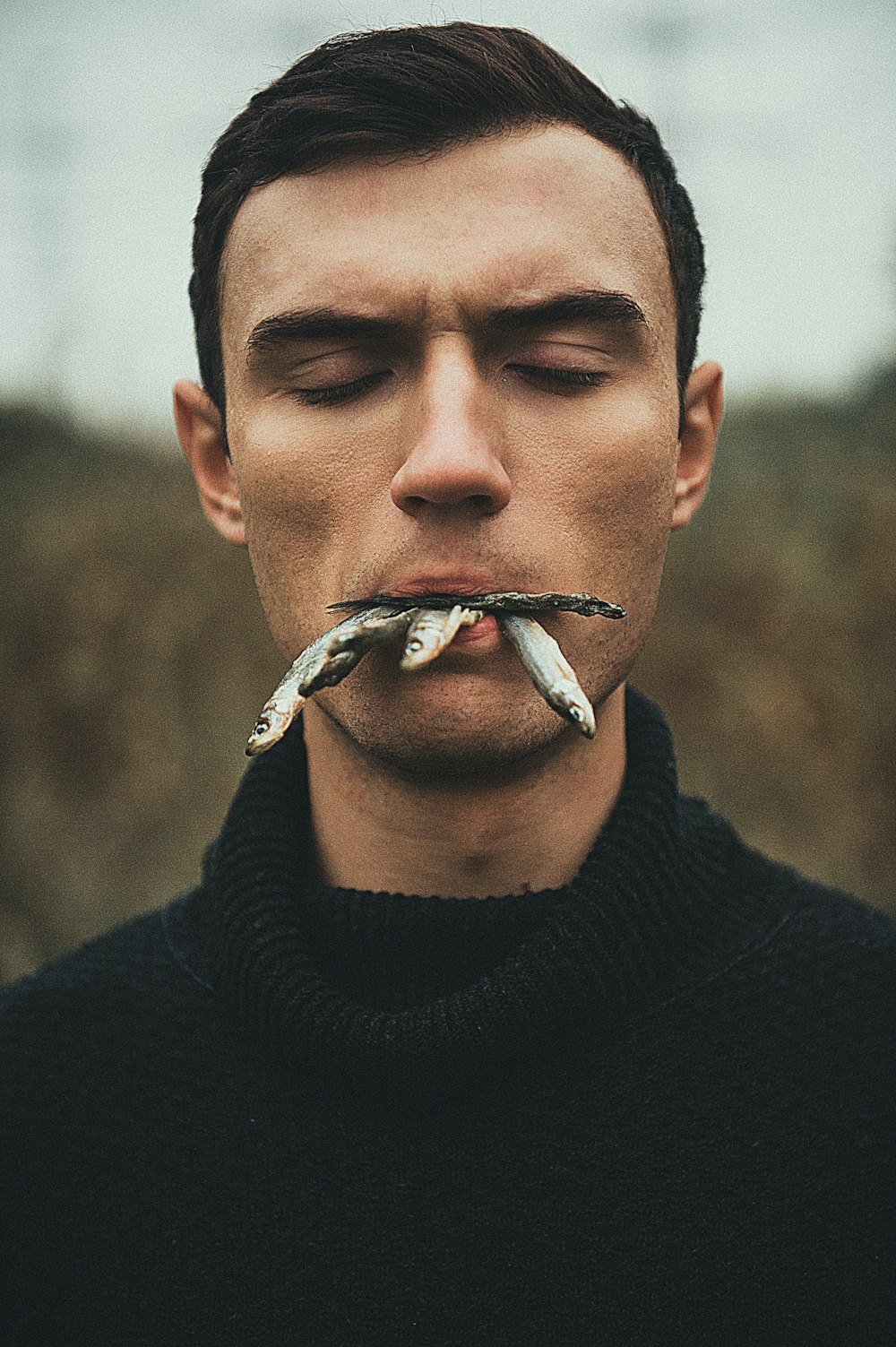 a man with a cigarette in his mouth