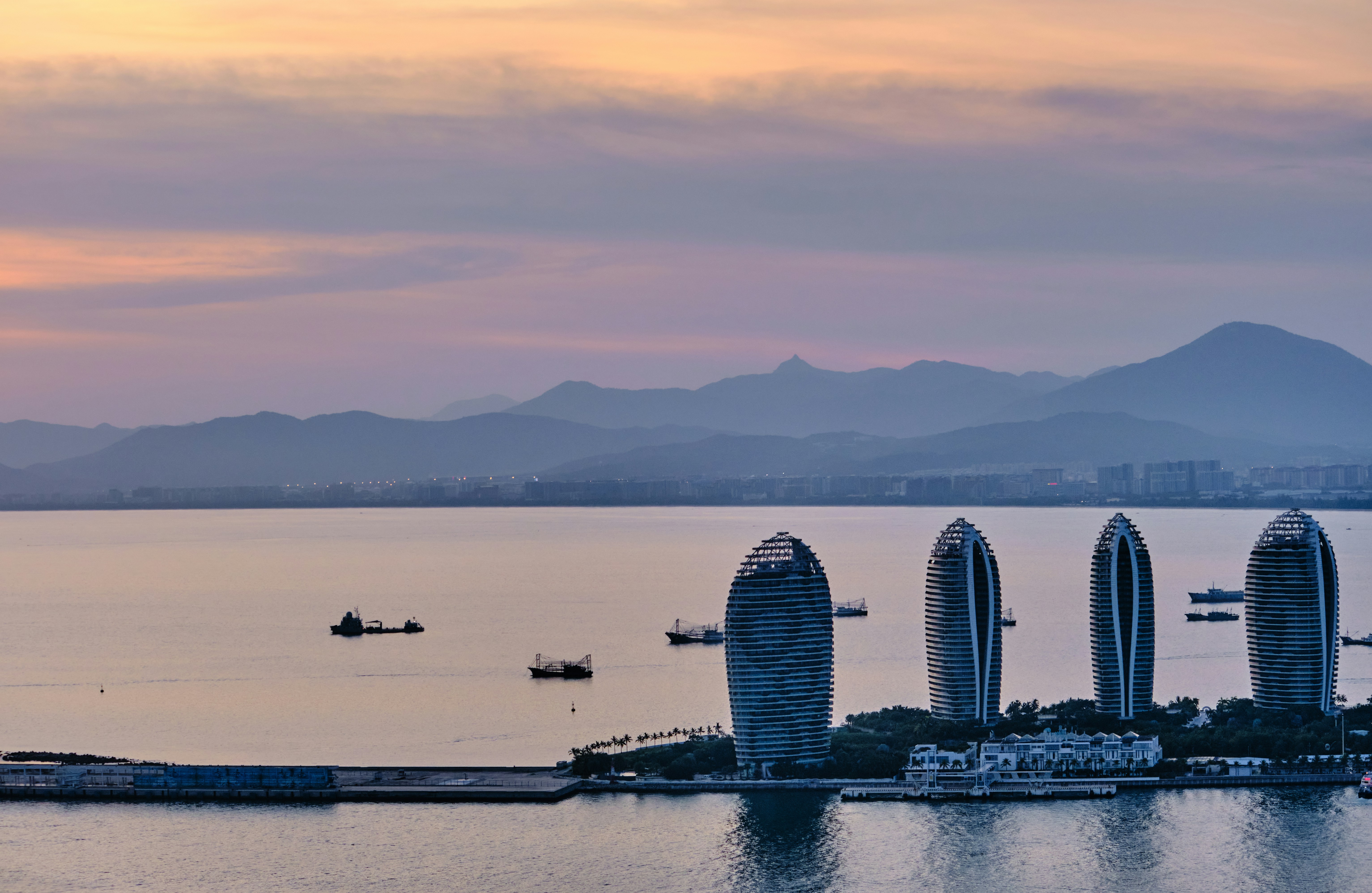 a group of tall buildings sitting on top of a body of water