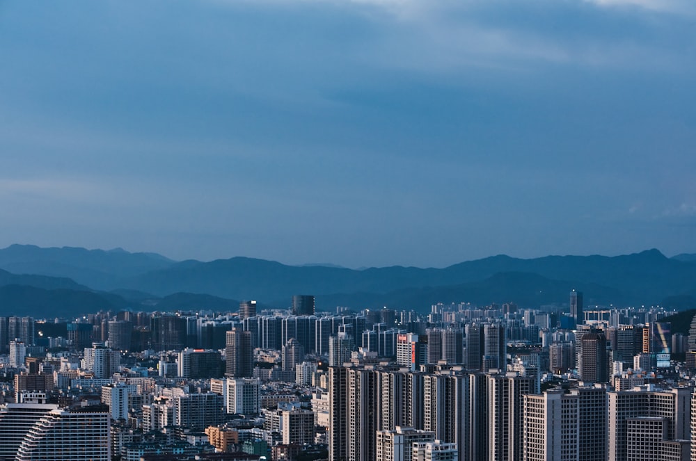 a view of a city with mountains in the background