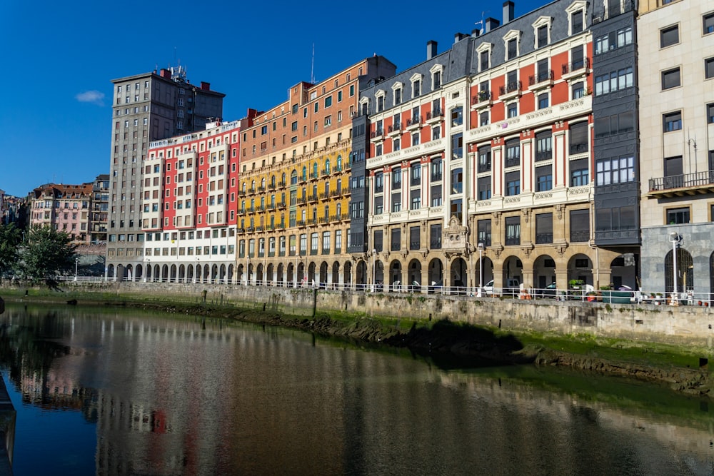 a row of buildings next to a body of water