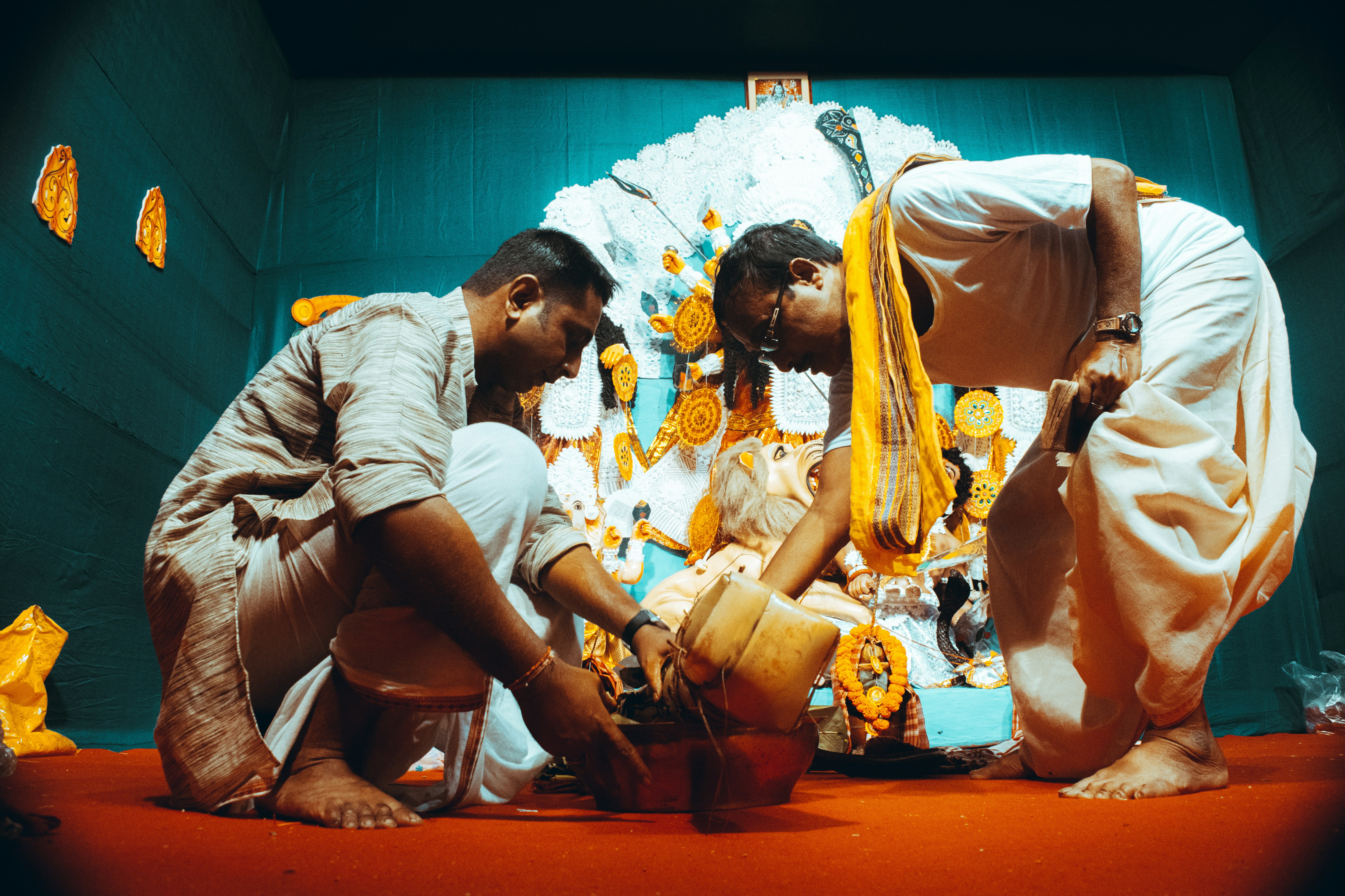 a couple of men kneeling down next to each other