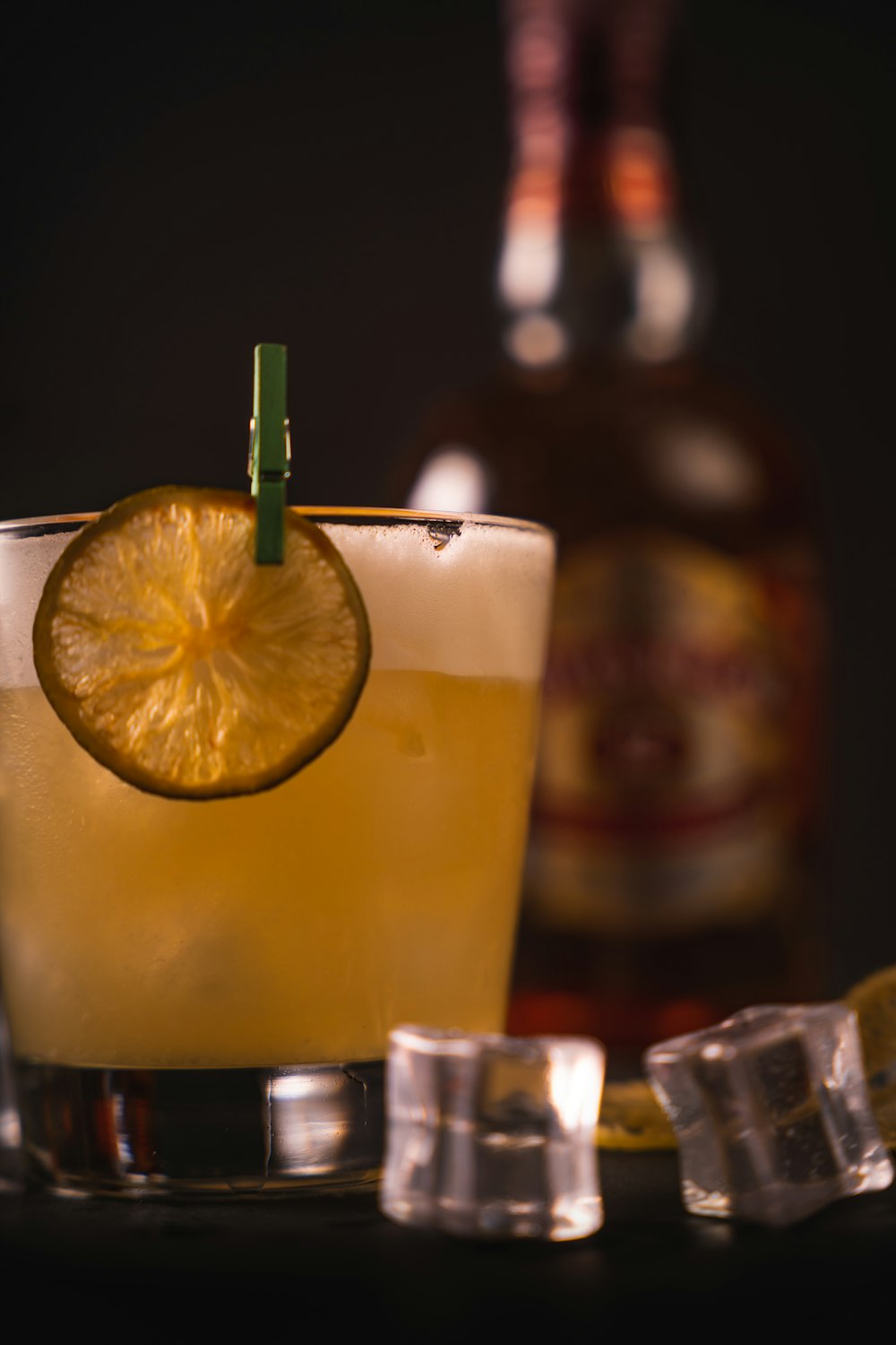 a close up of a drink with a slice of lemon